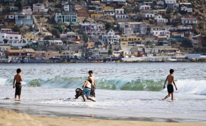 kids playing in the ocean in Chile