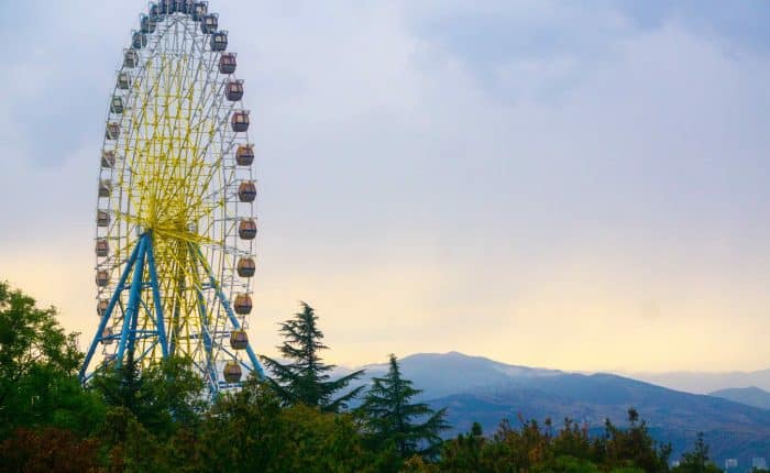 ferris wheel with mountains in the distance
