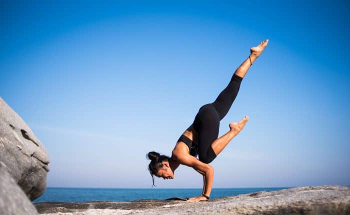 woman doing yoga on a mountain