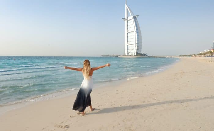 woman walking by the shore, the water crystal blue