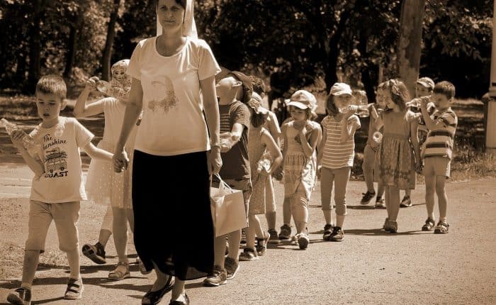 Teacher with her students walking outside
