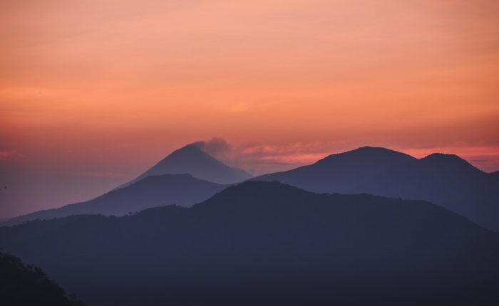 mountains beneath an orange sky