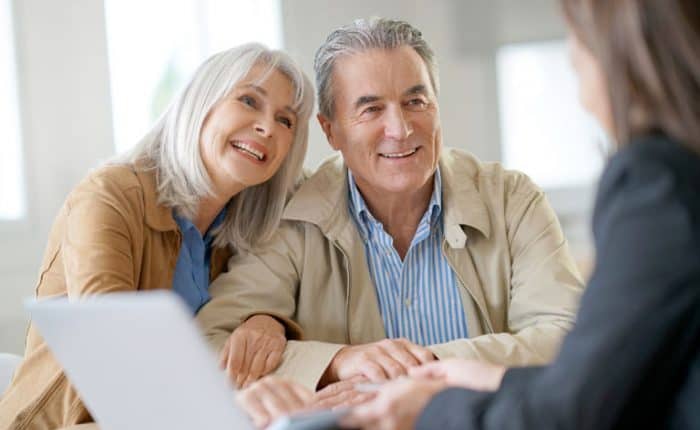 older couple talking with a woman