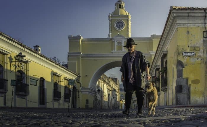 Man with his dog in a square in Guatemala