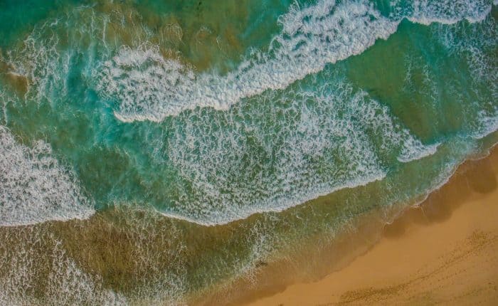 aerial view of blue-green waters meeting the shore
