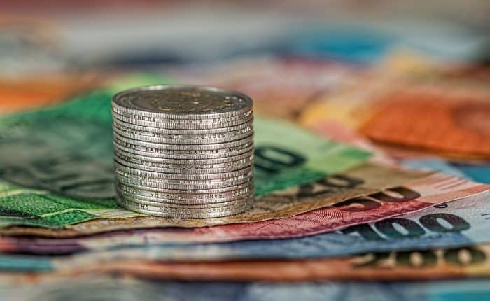 coins stacked on bills