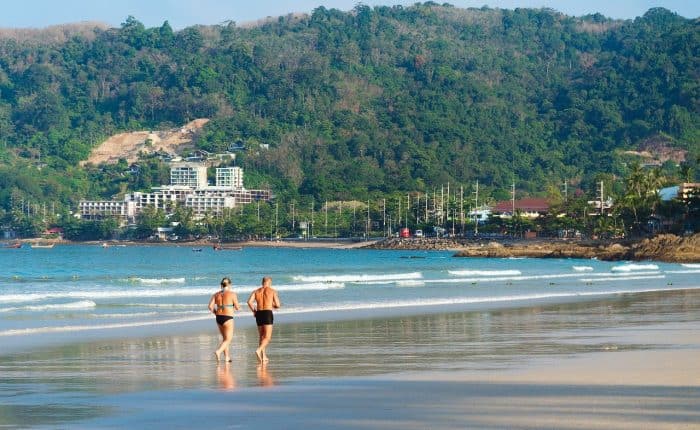 senior couple running on the beach