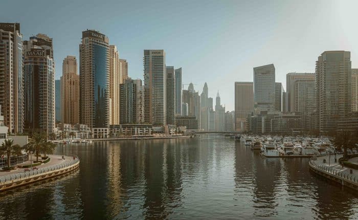 highrise buildings behind a beautiful river in the middle of the city