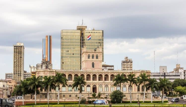hude building with a garden in front of it