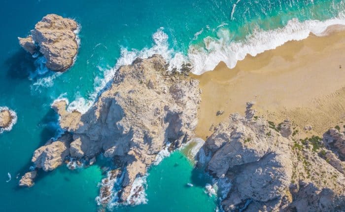 aerial view of the ocean meeting the shore