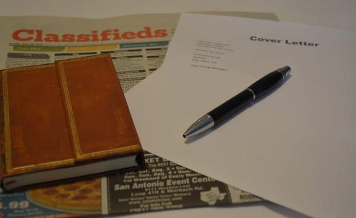 a newspaper with notebook and pen