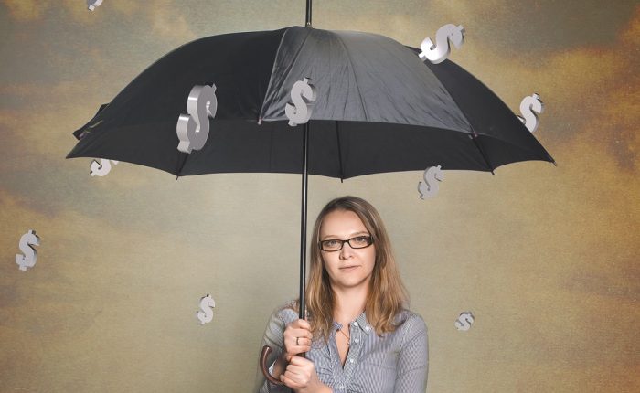 girl sitting under umbrella