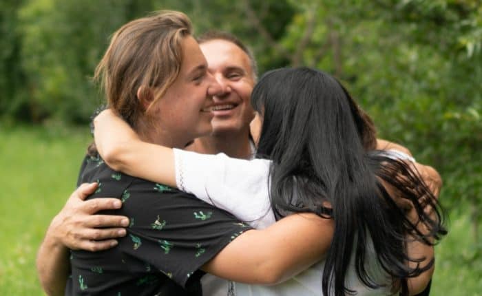 Three Adults hugging