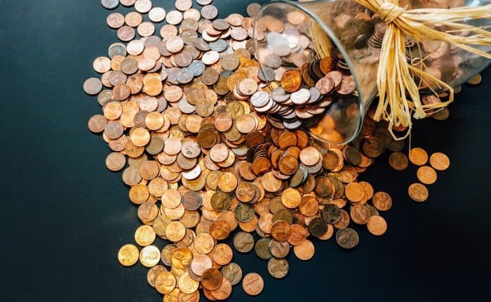 Coins falling out of a vase