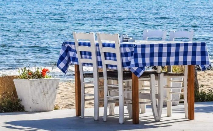 Table with cloth on it overlooking the sea in Greece