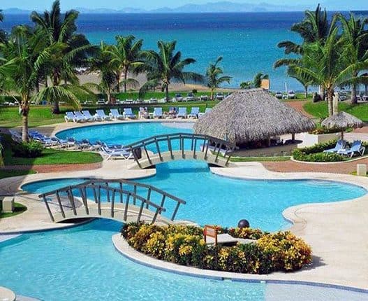 view of a beautiful swimming pool that leads towards the ocean